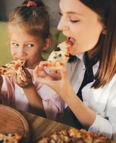 Kid eating Pizza With Mom