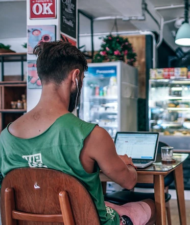 Digital Nomad Working in Cozy Coffee Shop Digital Nomad Working in Cozy Coffee Shop
