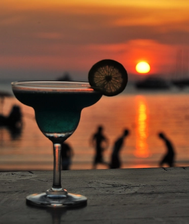 Cocktail with Scenic Sunset on the Background Cocktail with Scenic Sunset on the Background