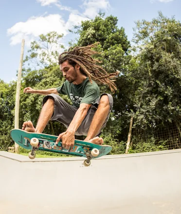 Skateboarder Hovering Doing Trick in Skatepark Ramp Skateboarder Hovering Doing Trick in Skatepark Ramp