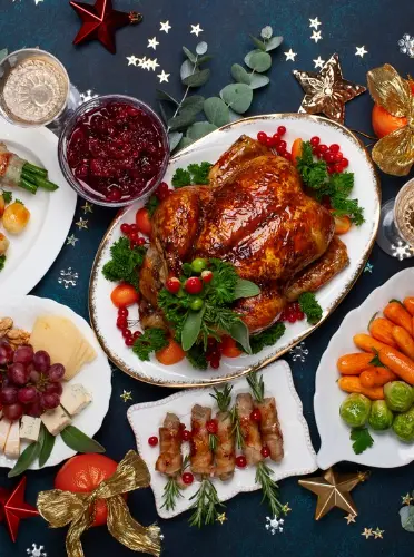 Christmas dinner spread with roasted turkey and festive dishes.