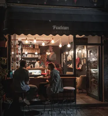 Two people having conversation in a cafe at night