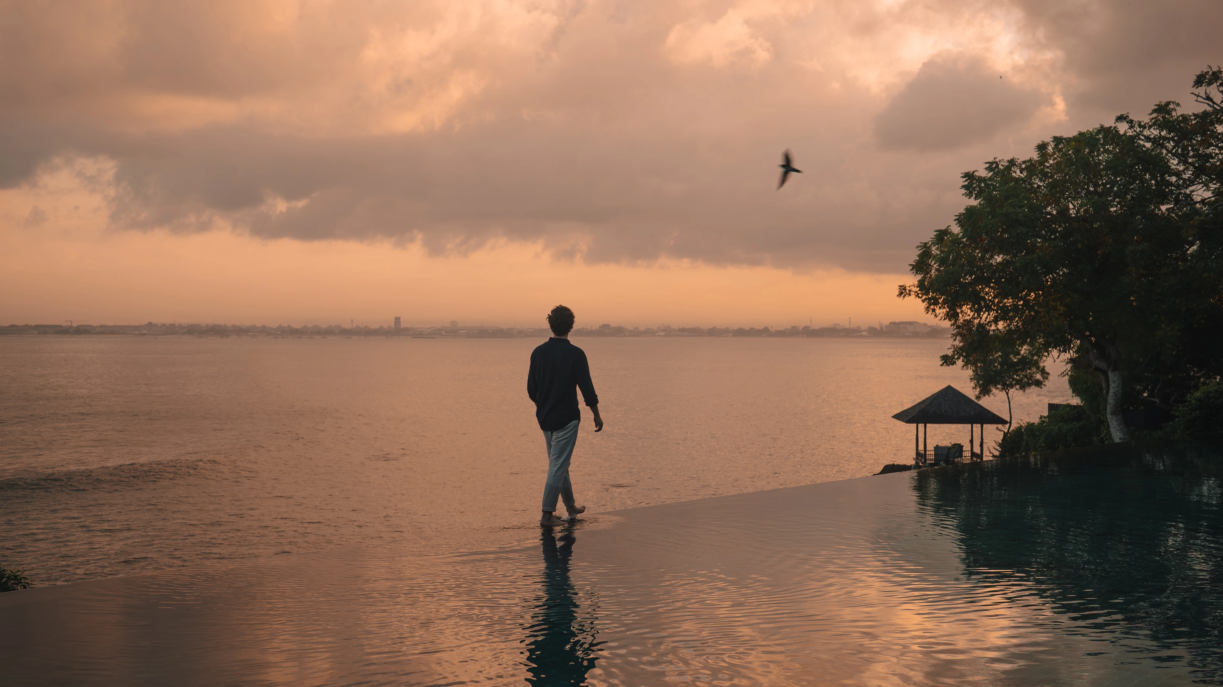 Guest at Main pool during sunset on Nyepi Day