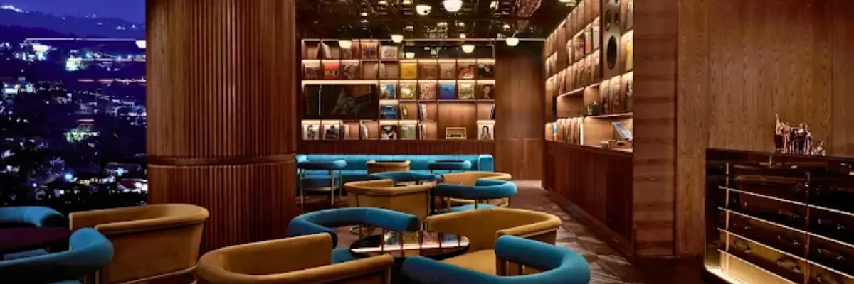 Vinyl listening bar interior with city views, record shelves, and lounge seating