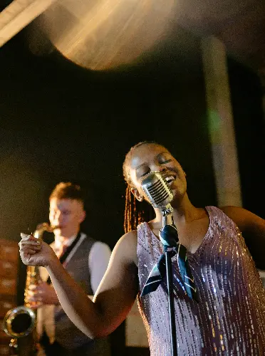 Live jazz performance with a female singer and saxophonist on stage
