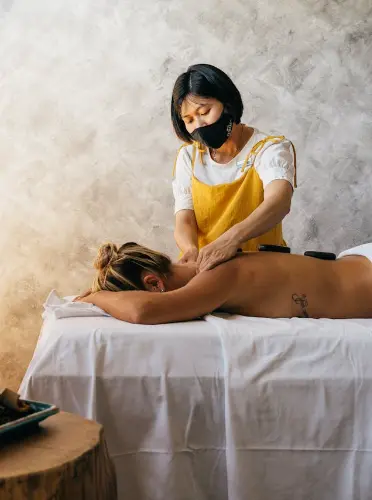 therapist doing back massage to client