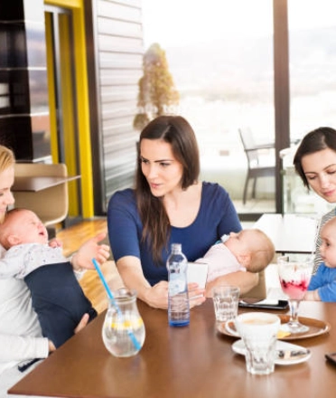 Parents dining with babies at a family-friendly café