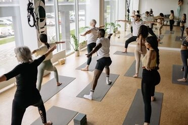 people doing yoga session in yoga studio
