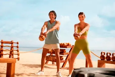 boy and girl working out on the beach