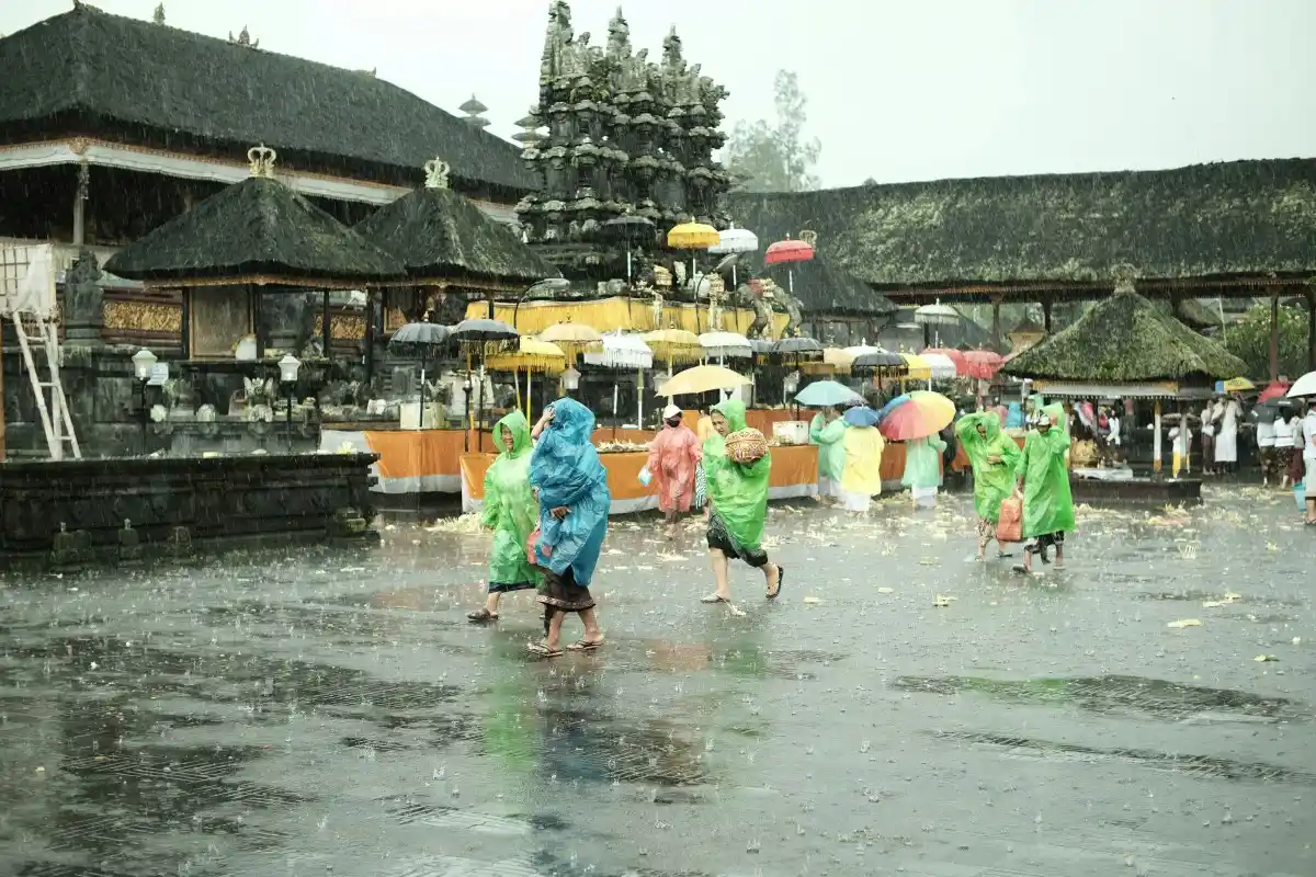 people in the bali temple raining