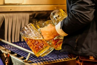 man holding glasses of beer