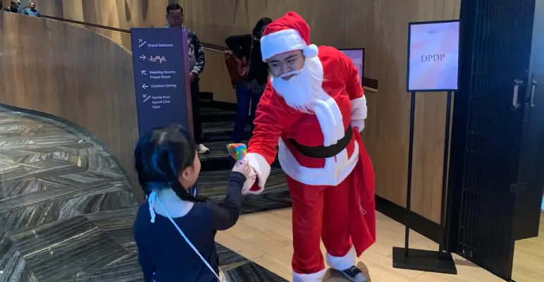Santa Claus handing out Lollipop